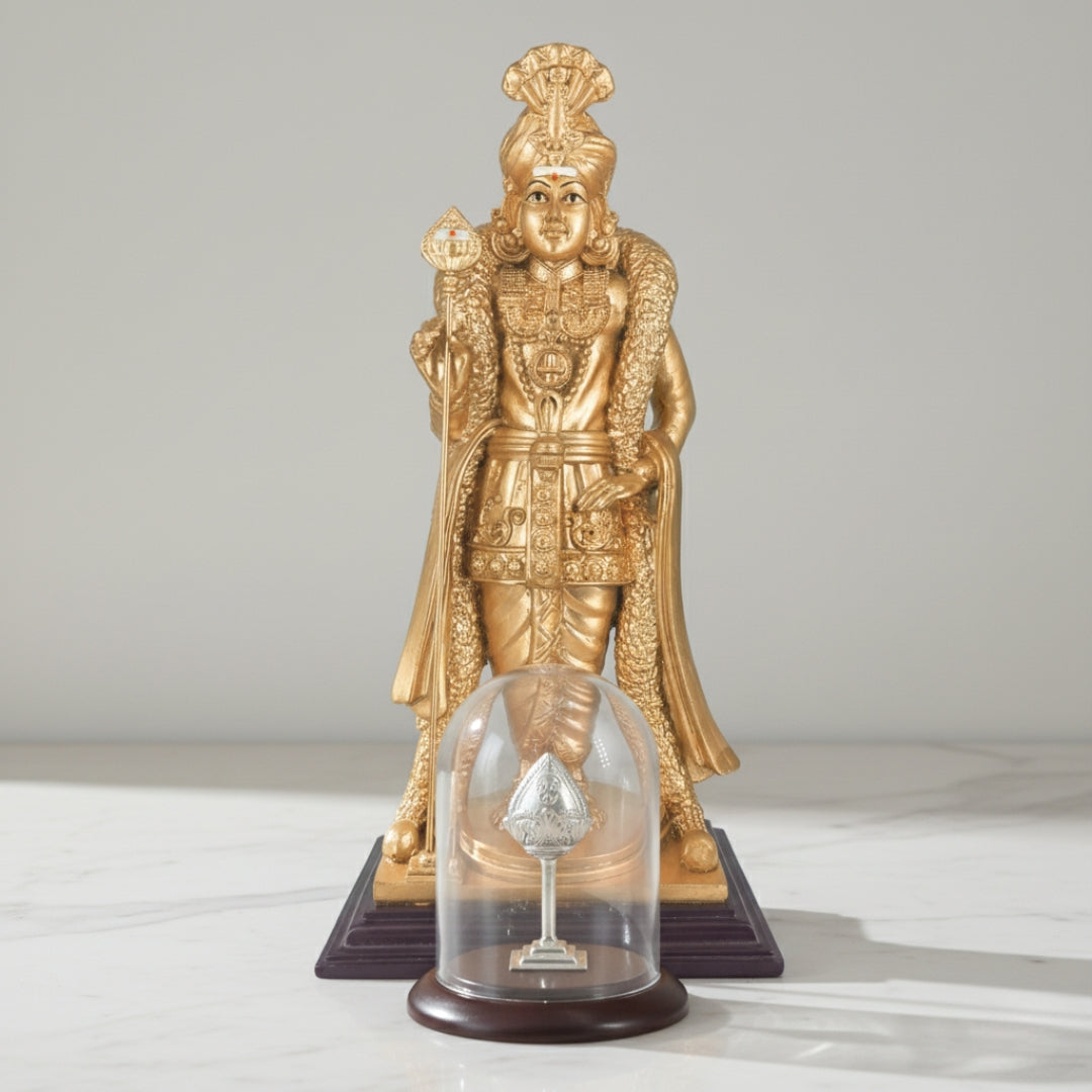Gold-colored Palani Raja Alangara Murugan statue on a decorative table with Silver Vel 
