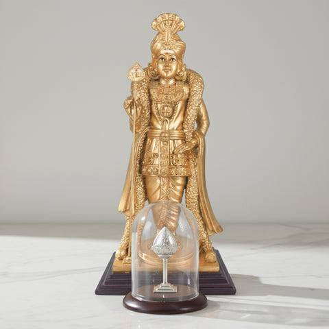 Gold-colored Palani Raja Alangara Murugan statue on a decorative table with Silver Vel 