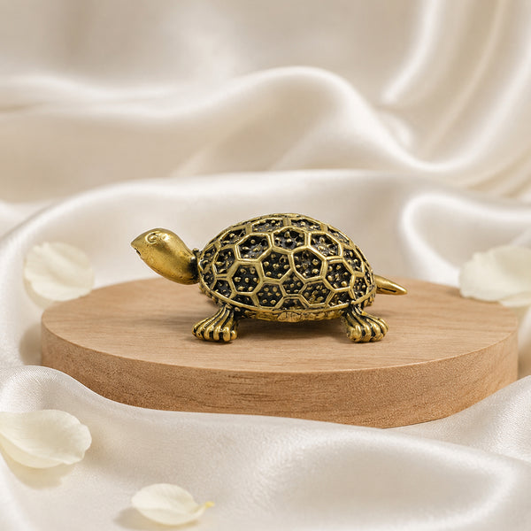 Side profile of the solid brass tortoise highlighting the antique gold finish.