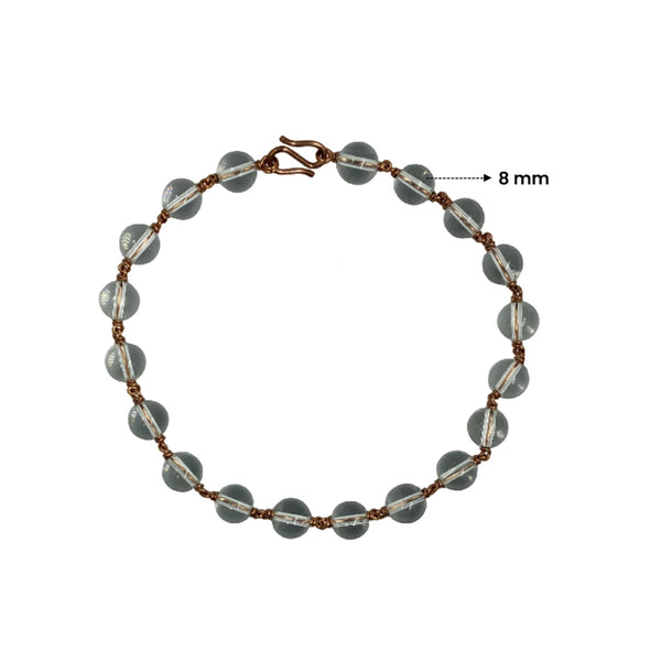 Close up of 8mm Spadigam Sphatik beads in a custom copper wire wrapped setting.
