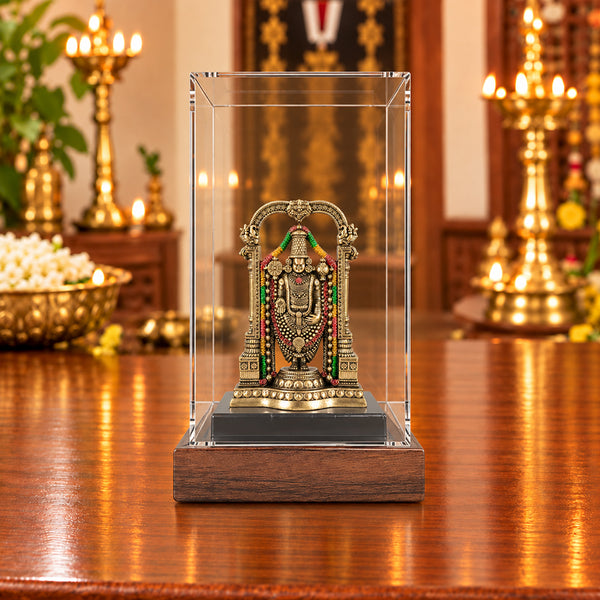 Tirupati Balaji fiber statue displayed inside a glass box with wooden base in a traditional South Indian pooja room
