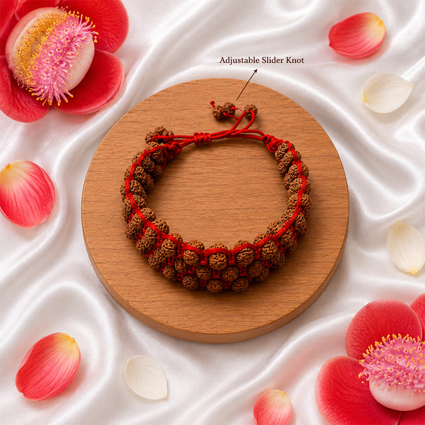 Detailed view of the premium red adjustable slider knot on a triple-layer Rudraksha protection bracelet.