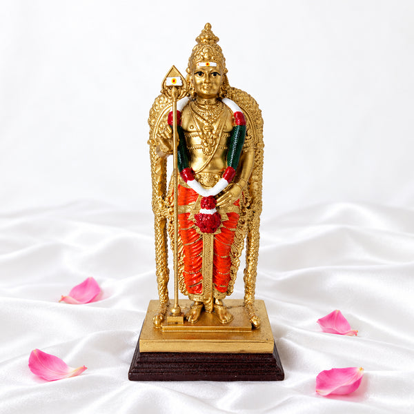 Front view of Malaysian Murugan statue with garland and vel on white silk with lotus petals