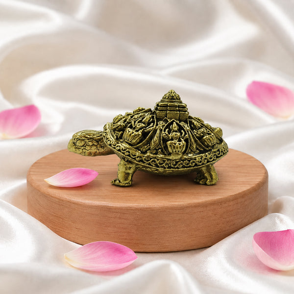 Side profile of the small 1.5-inch brass Vastu tortoise highlighting the elevated Meru center structure.
