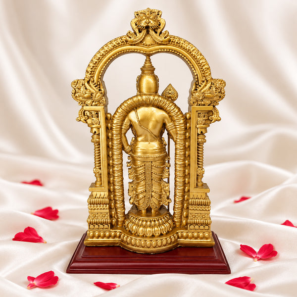 Back view of gold Murugan statue showing the crown, shoulders and carved temple arch