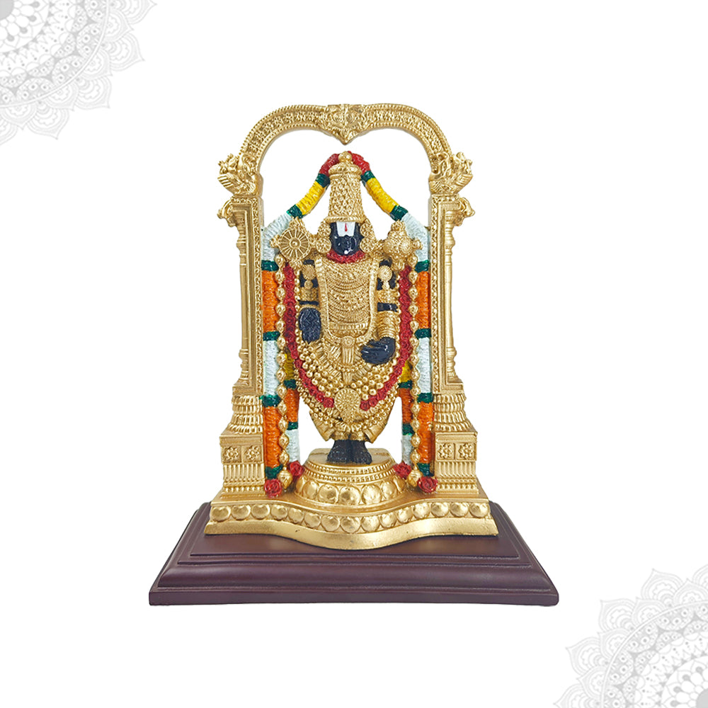 A gold-colored fiber statue of the Hindu god Perumal, depicting him in a seated position with a decorative canopy behind, placed on a brown base.