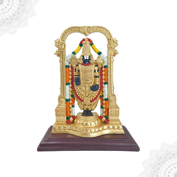 A gold-colored fiber statue of the Hindu god Perumal, depicting him in a seated position with a decorative canopy behind, placed on a brown base.