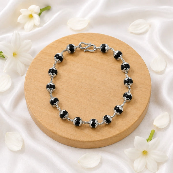 Premium Karungali (Ebony Wood) bracelet featuring silver-toned capped beads and a traditional secure S-hook clasp for a luxury spiritual look.