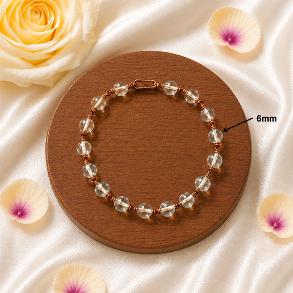 Close-up of 6mm Spadigam beads on a copper wire-wrapped healing bracelet.