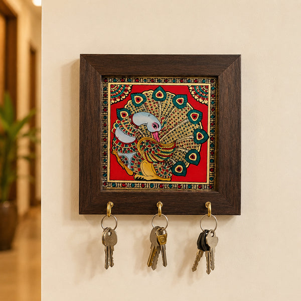 Tanjore art key hanger with fanned peacock painting and stone border