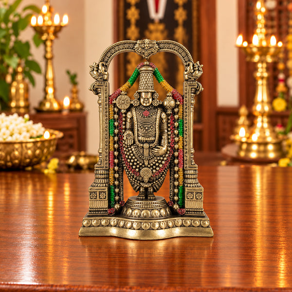 Tirupati Balaji Venkateswara fiber statue with colorful garland in a traditional temple setting