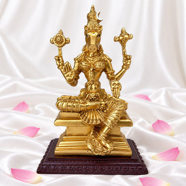 Front view of Varahi Amman statue holding chakra and shankha, on white silk with lotus petals