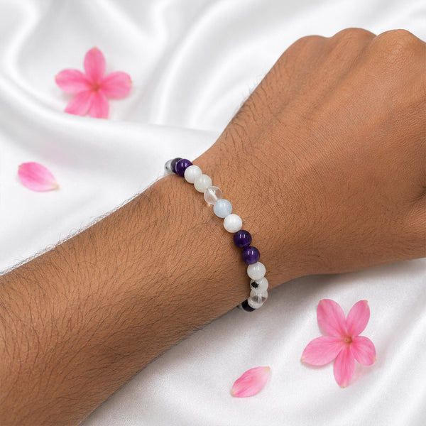 A person wearing the Chandrashtama stretchable crystal bracelet featuring moonstone and amethyst beads for emotional balance.