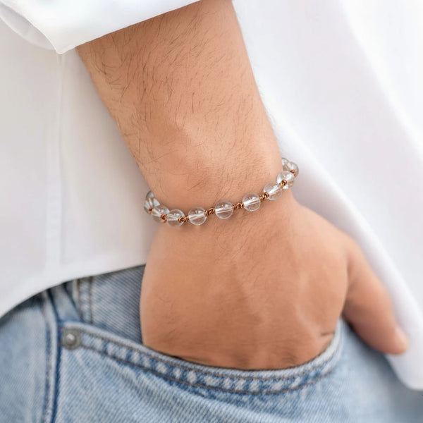 Person wearing a Spadigam Clear Quartz and copper bracelet for meditation and energy balancing.